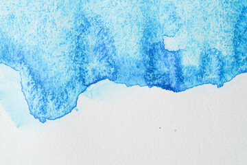 Background watercolor blue stains of paint on paper