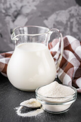 granulated milk powder on a dark stone background