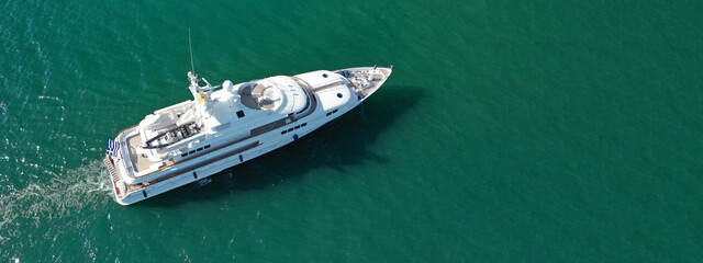 Aerial drone top down ultra wide panoramic photo of luxury yacht anchored in Mediterranean port