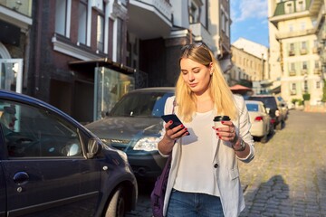 City portrait of young beautiful business woman walking down the street