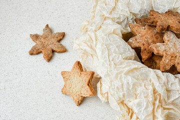 Freshly baked homemade in the form of a star on a light background. Close-up.