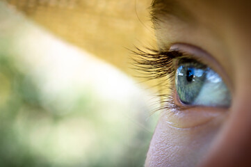 Girl's blue eye, view to something, detail of face, blue eyes, summer time