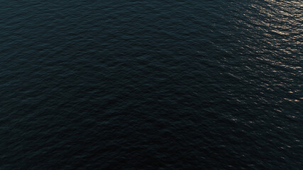 Calm waves in the sea aerial view with sun reflection