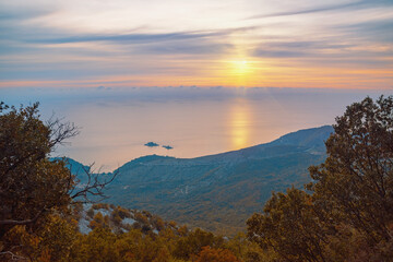 Autumn sunset. Sun, sea and mountains. Montenegro, coast of Adriatic Sea near town of Budva