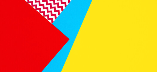 Abstract geometric fashion papers texture background in yellow, red, pink, blue colors. Top view, flat lay