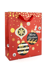 Red Christmas shopping bag made of paper decorated with Christmas balls on a white background. New year and gifts concept..