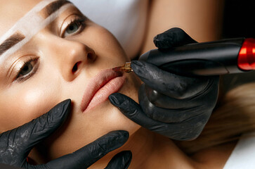 Pretty model having permanent makeup on her lips