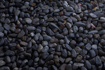Black Pebbles close up macro detail round river bed drift rock flatlay background dark moody