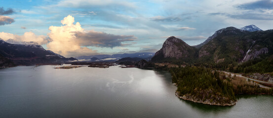 Aerial Panoramic view of Sea to Sky Highway with Chief Mountain in the background. Colorful Sunset Sky Art Render. Taken near Squamish, North of Vancouver, British Columbia, Canada.