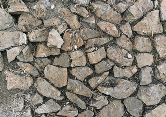 Texture, background of old, stone, cobblestone on an abandoned earth surface.