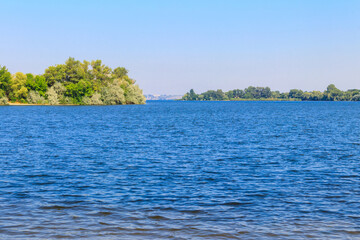 Obraz premium Summer landscape with beautiful river, green trees and blue sky