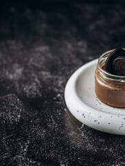 chocolate spread in a jar with cookies, half a jar. space for text