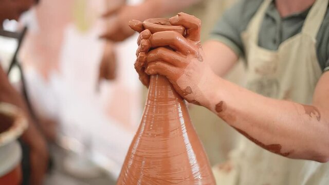 Pottery girl enjoying pottery art and production process. Hand work. Close-up.