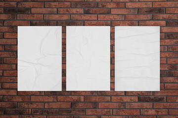 Blank creased posters on brick wall. Mockup for design