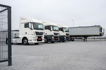 Trucks with cargo trailers in the parking lot, Freight transport by road, Logistics and cargo transportation concept