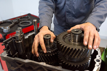 An auto mechanic repairs a truck engine. Service of trucks in the garage. Close-up