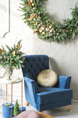 Christmas interior with armchair and christmas wreath