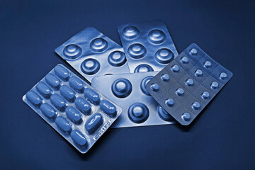 Blister packs of pills on blue tones