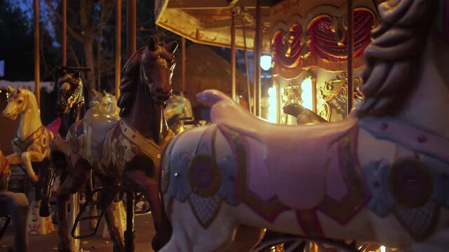 Illuminated carousel at night in an amusement park 4k