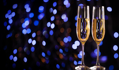 Christmas illuminations and champagne glass. Happy New Year. Christmas and New Year holidays background