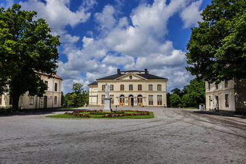 Obraz premium Court Theatre and the Marble statue of Apollo near Drottningholm Palace in Stockholm, Sweden. Palace is the most well preserved royal castle built in the 1600s in Sweden.