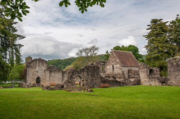 Fototapeta na wymiar View of remains of the Inchmahome Priory, Menteith Lake, Scotland. Concept: religion and spirituality, mysterious and fantastic places in Scotland