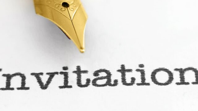 Fountain pen on invitation text dolly shot.