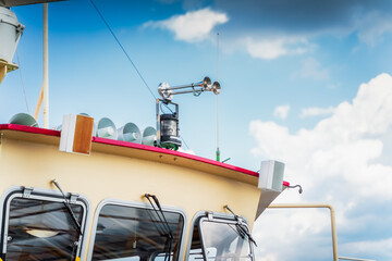 Two chrome ship sirens and set of loudspeakers on the top of the cabin. Closeup on nautical...