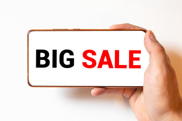 Closeup of smartphone with white screen and sign - Big Sale in female hand.