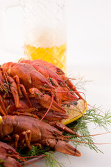 Crayfish boiled on a dish with dill spices and lemon.
