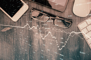 Multi exposure of forex graph hologram over desktop with phone. Top view. Mobile trade platform concept.