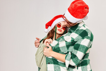 man warms woman hugs new year holiday sunglasses