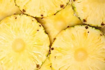 Slices of tasty ripe pineapple as background, top view