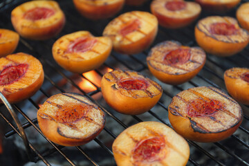 Modern grill with tasty cut peaches, closeup