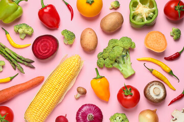 Flat lay composition with fresh vegetables on pink background