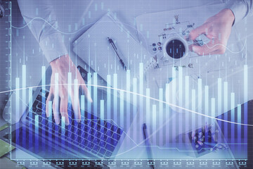 Multi exposure of man's hands typing over computer keyboard and forex graph hologram drawing. Top view. Financial markets concept.