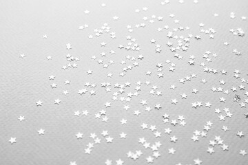 Confetti stars on grey background. Christmas celebration