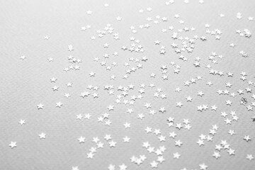 Confetti stars on grey background. Christmas celebration