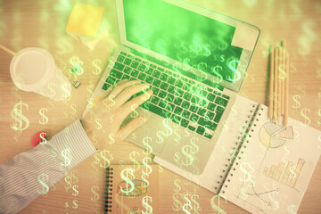 Double exposure of man's hands typing over computer keyboard and forex graph hologram drawing. Top view. Financial markets concept.