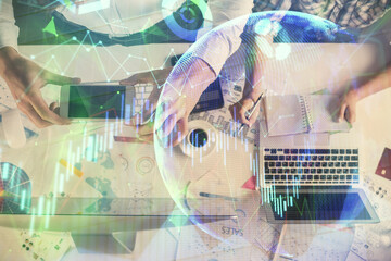 Double exposure of man and woman working together and financial chart hologram drawing. market analysis concept. Computer background. Top View.