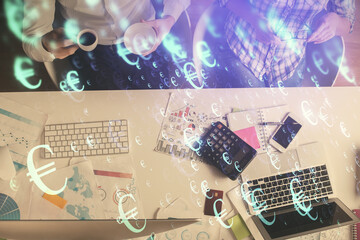 Double exposure of man and woman working together and financial chart hologram drawing. market...