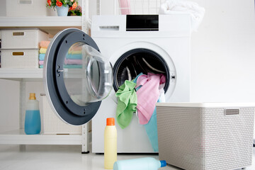 Inside the laundry room with a washing machine and detergent.