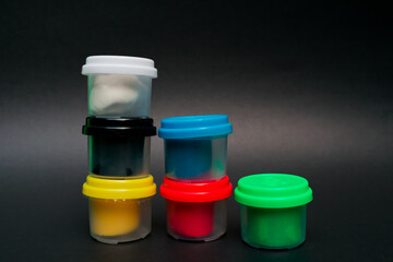 plastic containers with modeling clay, six colors