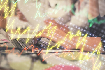 Multi exposure of woman hands typing on computer and financial graph hologram drawing. Stock market analysis concept.