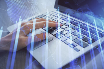 Double exposure of woman hands typing on computer and forex chart hologram drawing. Stock market analysis concept.