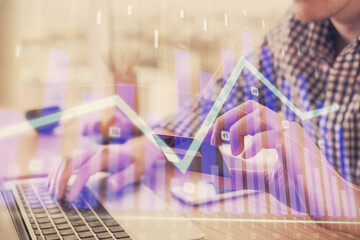 Double exposure of man hands holding a credit card and Forex graph drawing. Stock trading and digital fintech in Internet E-commerce concept.