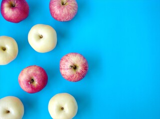 Red apple and yellow apple on blue background