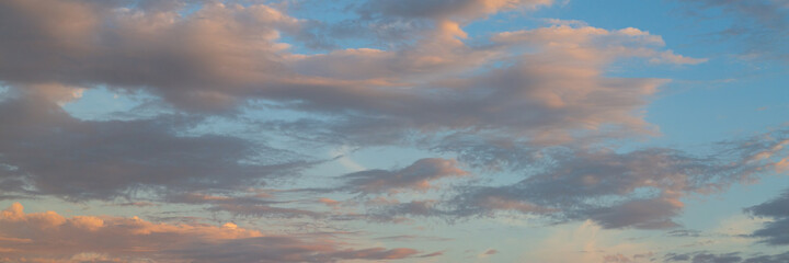 Beautiful sunset sky background with clouds. Scenic cloudscape. Wide panoramic background for...