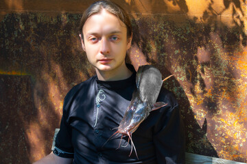 fishing scene, man holding a giant catfish