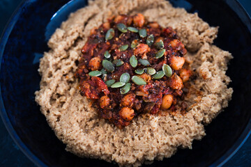 plant-based food, vegan chickpea tomato and mushroom stew with spicy couscous